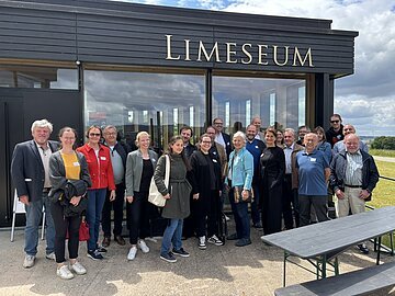 Gruppenfoto Runder Tisch Museen LIMESEUM Es handelt sich um ein Gruppenfoto von etwa 20  erwachsenen Personen verschiedenen Alters, die vor dem LIMESEUM in Ruffenhofen stehen